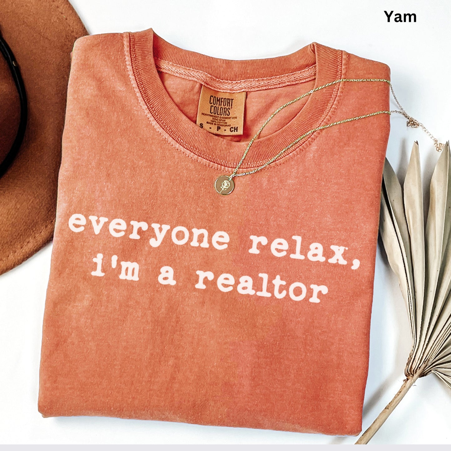 a red t-shirt with the text "Everyone relax, I'm a realtor" printed on it.