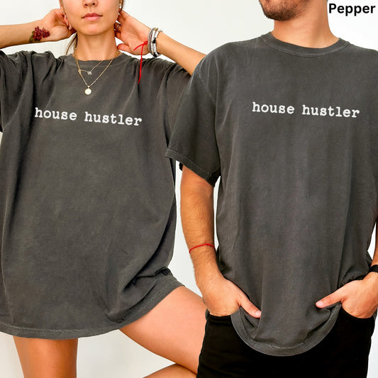 A man and a woman wearing matching gray t-shirts with the text "house hustler" printed on them.