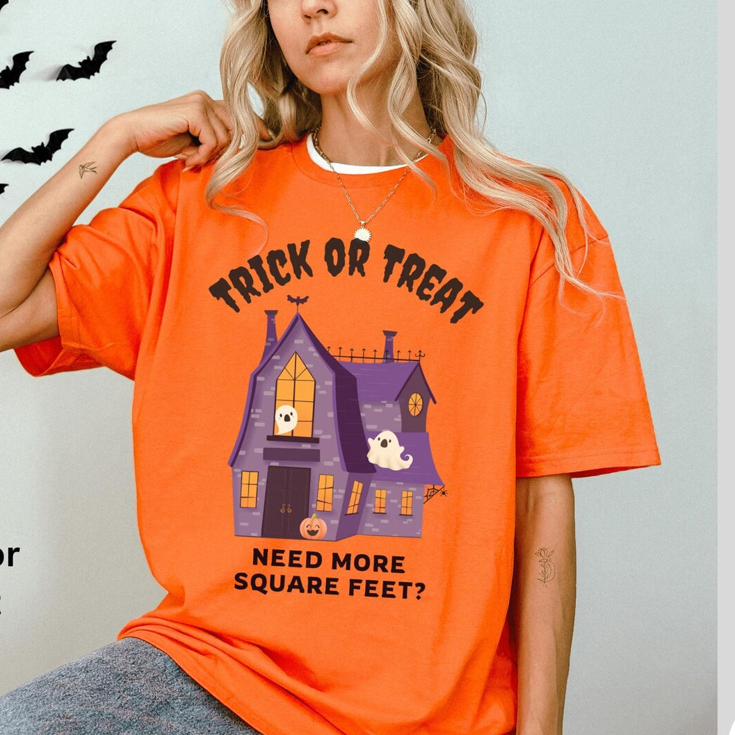 Person wearing an orange Halloween-themed t-shirt with text and graphics.