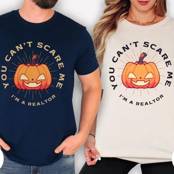 Two people wearing t-shirts with a pumpkin graphic and text, one navy and one natural.