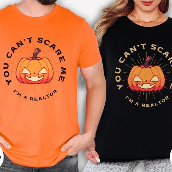 Two people wearing Halloween-themed t-shirts with a pumpkin graphic and text.