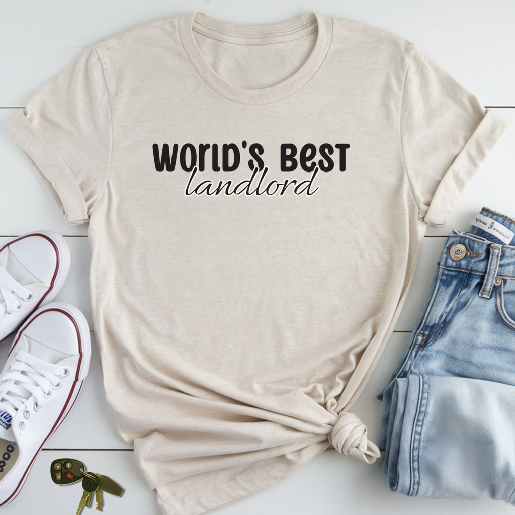 A beige t-shirt with the text "WORLD'S BEST landlord" printed on it, along with a pair of jeans and white sneakers.