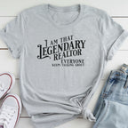 A gray t-shirt with a humorous text printed on it, along with a pair of jeans and white sneakers.