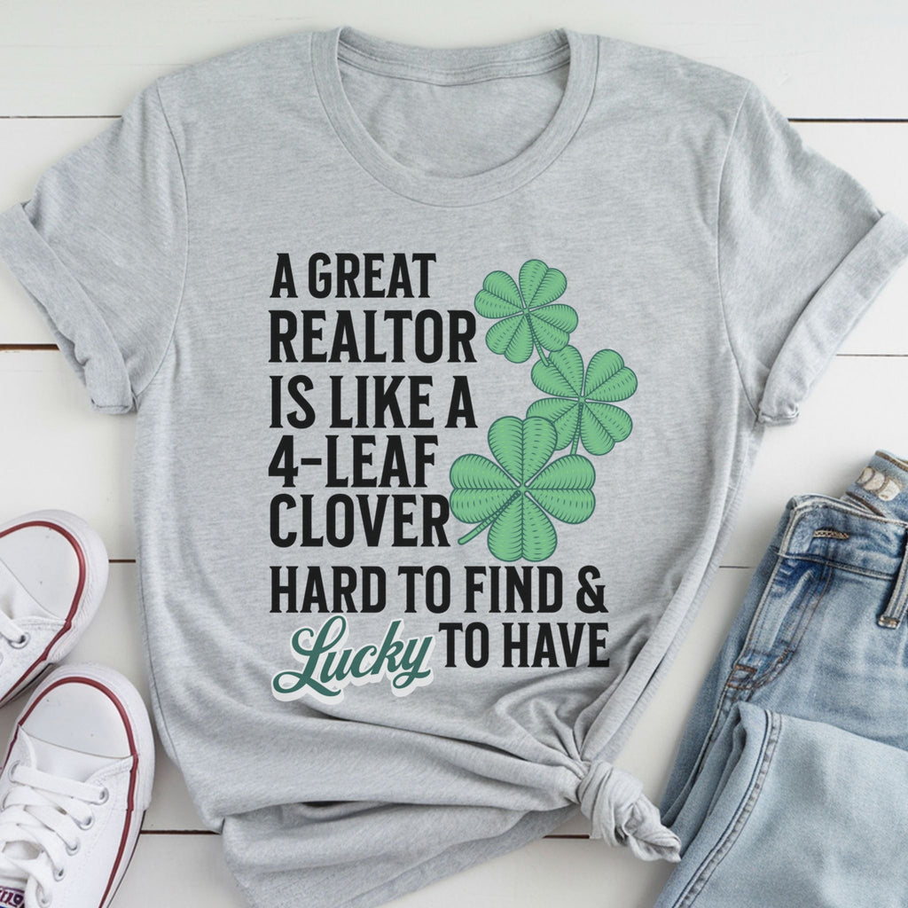 A gray t-shirt with a humorous text and cloverleaf design printed on it, along with a pair of jeans and white sneakers.