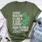 A green t-shirt with a humorous text and clover design, along with a pair of jeans, sunglasses, and a keychain.