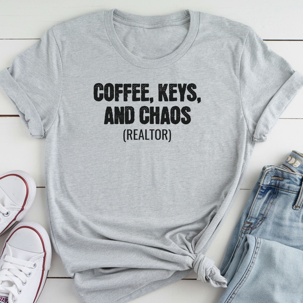 A gray t-shirt with the text "COFFEE, KEYS, AND CHAOS (REALTOR)" printed on it, along with a pair of jeans and white sneakers.