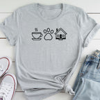 A gray t-shirt with a graphic design of a coffee cup, a paw print, and a house, along with a pair of jeans and white sneakers.