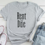 A gray t-shirt with the text "Rent is Due" printed on it, along with a pair of jeans and white sneakers.