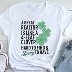 A white t-shirt with a humorous text and cloverleaf design printed on it.