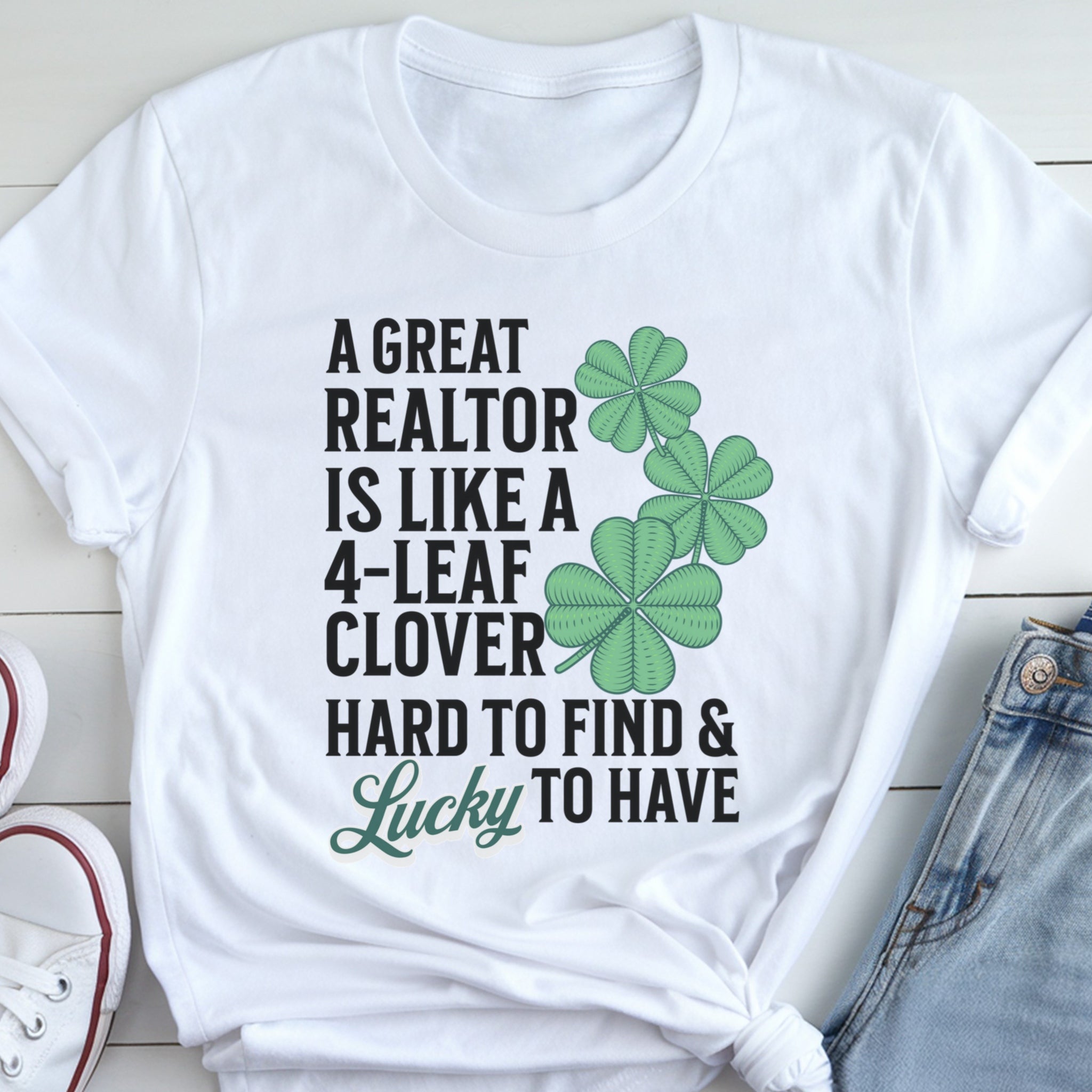 A white t-shirt with a humorous text and cloverleaf design printed on it.