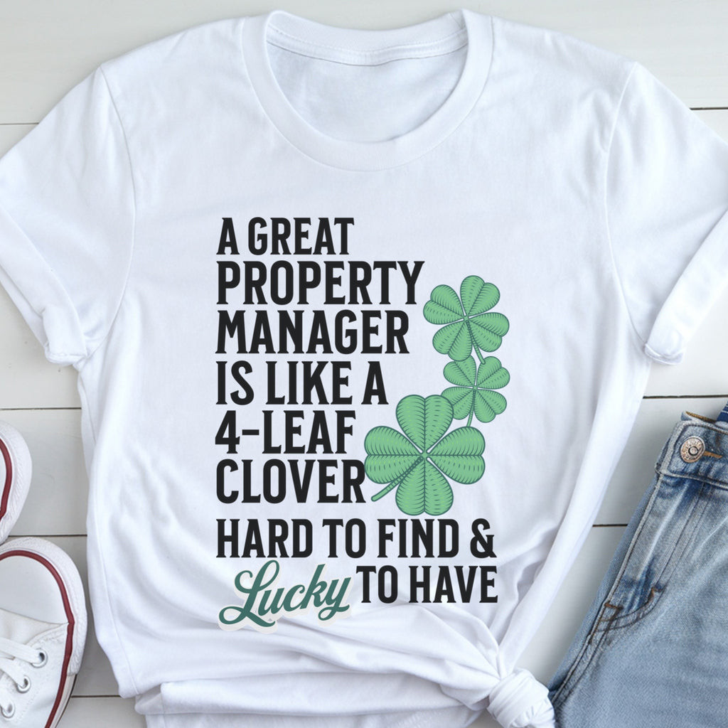 A white t-shirt with a humorous text and clover design printed on it.