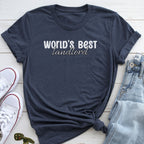 A dark blue t-shirt with the text "WORLD'S BEST landlORD" printed on it, along with a pair of jeans and white sneakers.