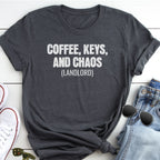A gray t-shirt with the text "COFFEE, KEYS, AND CHAOS (LANDLORD)" printed on it, along with a pair of jeans and sunglasses.