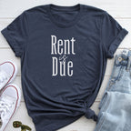 A dark blue t-shirt with the text "Rent is Due" printed on it, along with a pair of jeans and white sneakers.