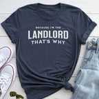 A navy blue t-shirt with the text "BECAUSE I'M THE LANDLORD THAT'S WHY" printed on it, along with a pair of jeans and white sneakers.