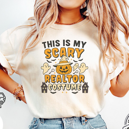 A woman wearing a white t-shirt with a Halloween-themed graphic design, including a jack-o-lantern, bats, and ghostly figures.