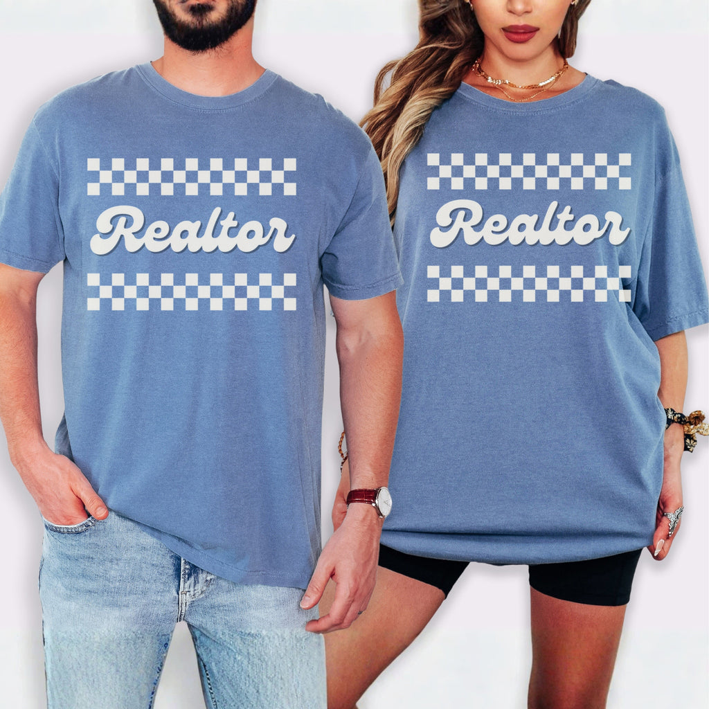 A man and a woman wearing matching blue t-shirts with the word "Realtor" printed on them.