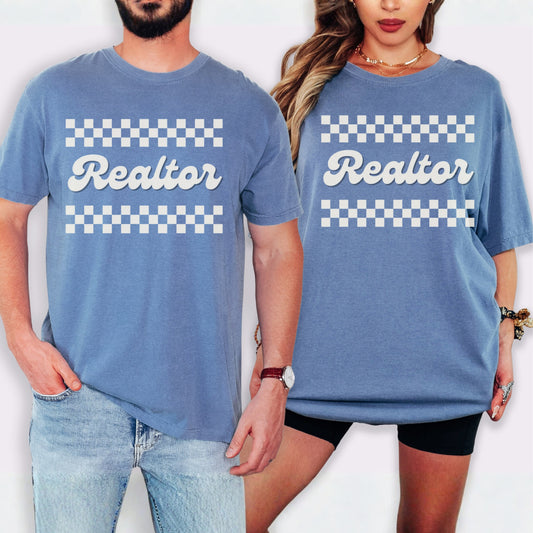 A man and a woman wearing matching blue t-shirts with the word "Realtor" printed on them.