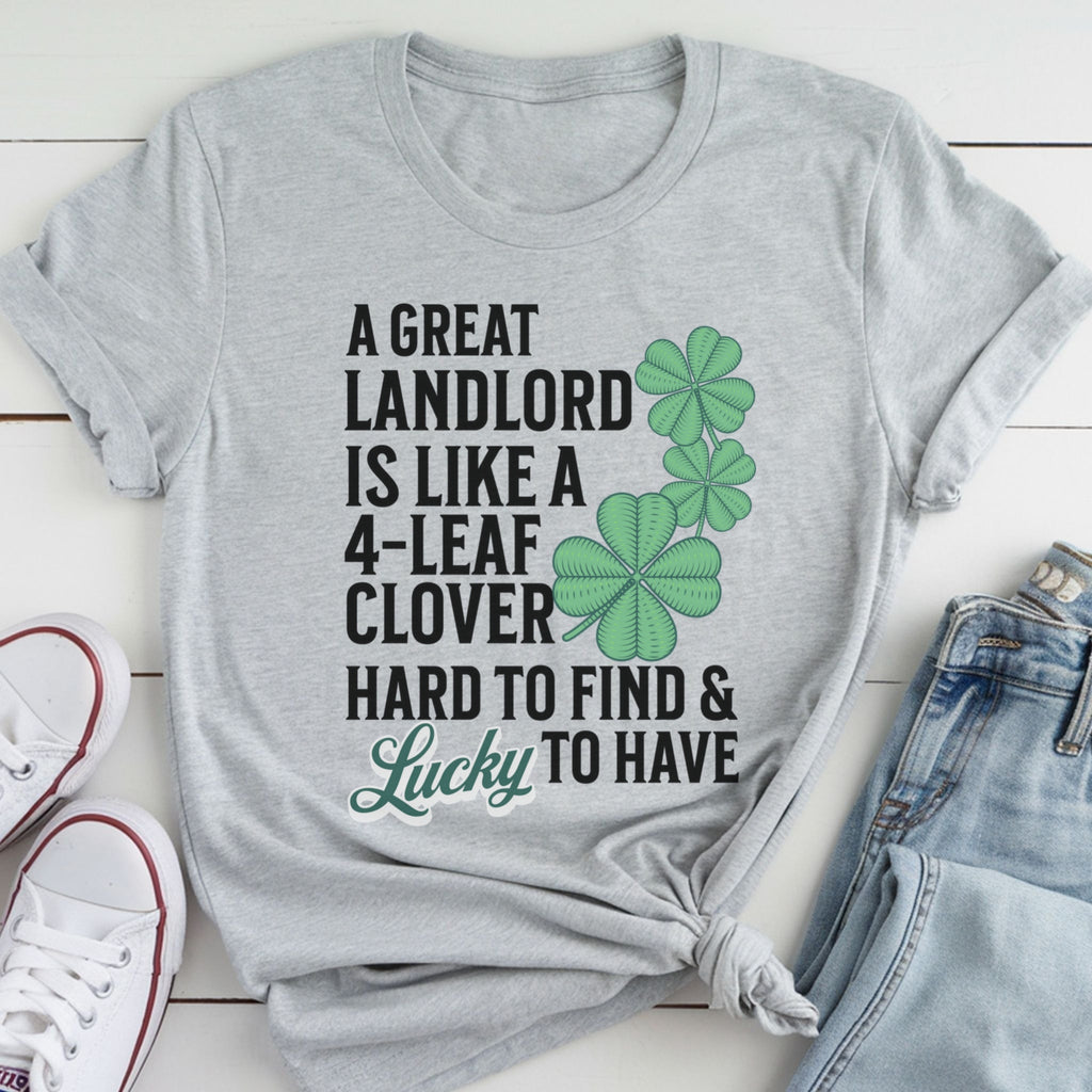 A gray t-shirt with a humorous text and cloverleaf design printed on it, along with a pair of jeans and white sneakers.