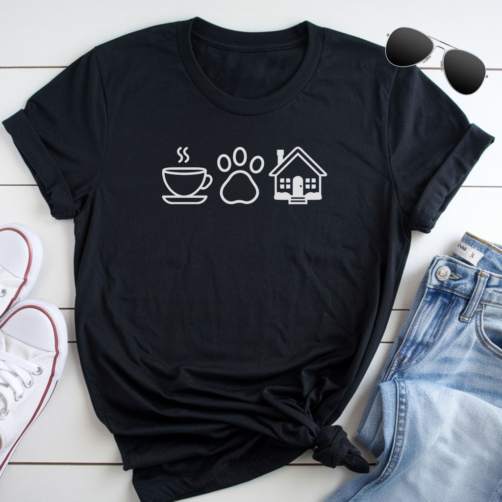 A black t-shirt with white icons of a cup, a paw print, and a house, along with a pair of jeans and sunglasses, all laid out on a white surface.