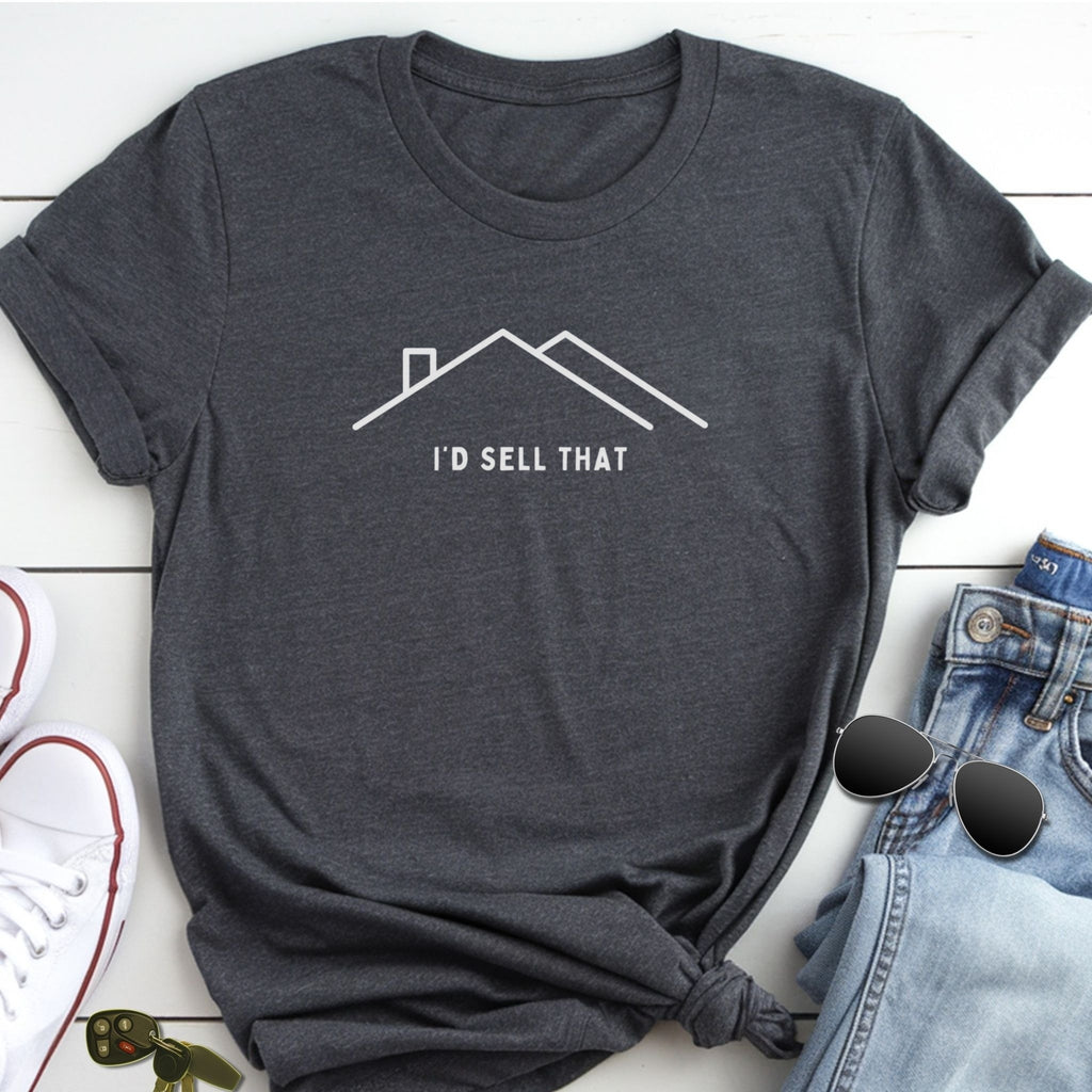 A gray t-shirt with a white graphic of a house and the text "I'D SELL THAT" printed on it, along with a pair of jeans and sunglasses.