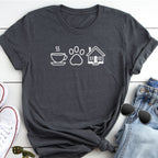 A gray t-shirt with white icons of a coffee cup, paw print, and house, along with a pair of jeans and sunglasses, all laid out on a white surface.