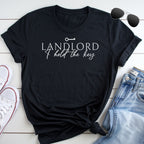 A black t-shirt with the text "LANDLORD I hold the key" printed on it, along with a pair of sunglasses and a pair of jeans.