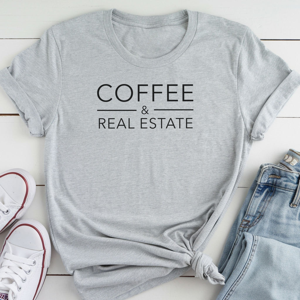 A gray t-shirt with the text "COFFEE & REAL ESTATE" printed on it, along with a pair of jeans and white sneakers.