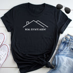 a black t-shirt with a white graphic design, a pair of jeans, and a pair of sunglasses, all laid out on a white surface.