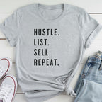 A gray t-shirt with the text "HUSTLE. LIST. SELL. REPEAT." printed on it, along with a pair of jeans and white sneakers.