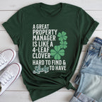 A green t-shirt with white text and a clover graphic, along with a pair of jeans and white sneakers, all laid out on a white surface.