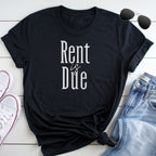 A black t-shirt with the text "Rent is Due" printed on it, along with a pair of jeans and sunglasses.