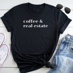 A black t-shirt with the text "coffee & real estate" printed on it, along with a pair of sunglasses and a pair of jeans.