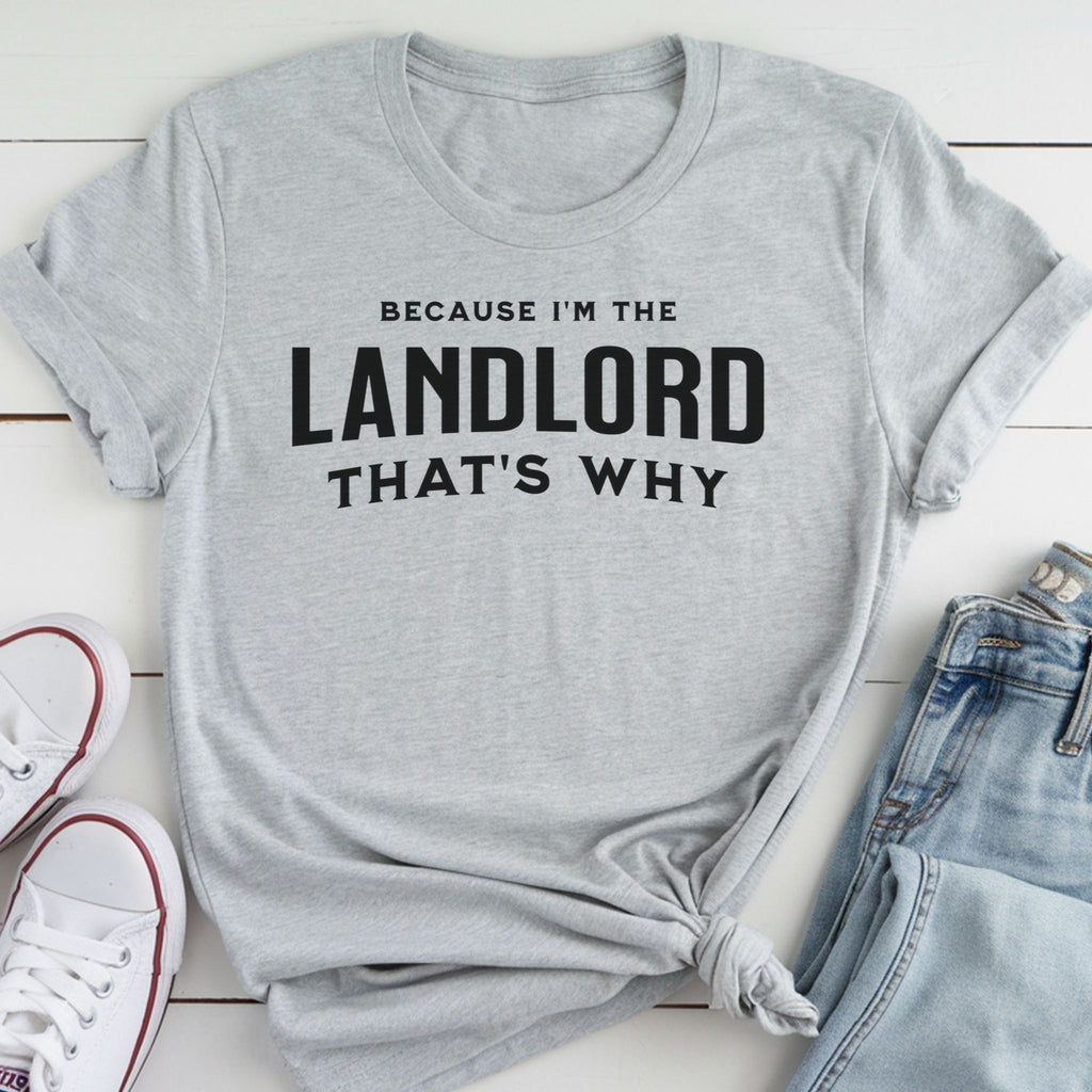 A gray t-shirt with the text "BECAUSE I'M THE LANDLORD THAT'S WHY" printed on it, along with a pair of jeans and white sneakers.