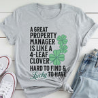 A gray t-shirt with a humorous text printed on it, along with a pair of jeans and white sneakers.