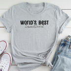 A gray t-shirt with the text "WORLD'S BEST landlORD" printed on it, along with a pair of jeans and white sneakers.