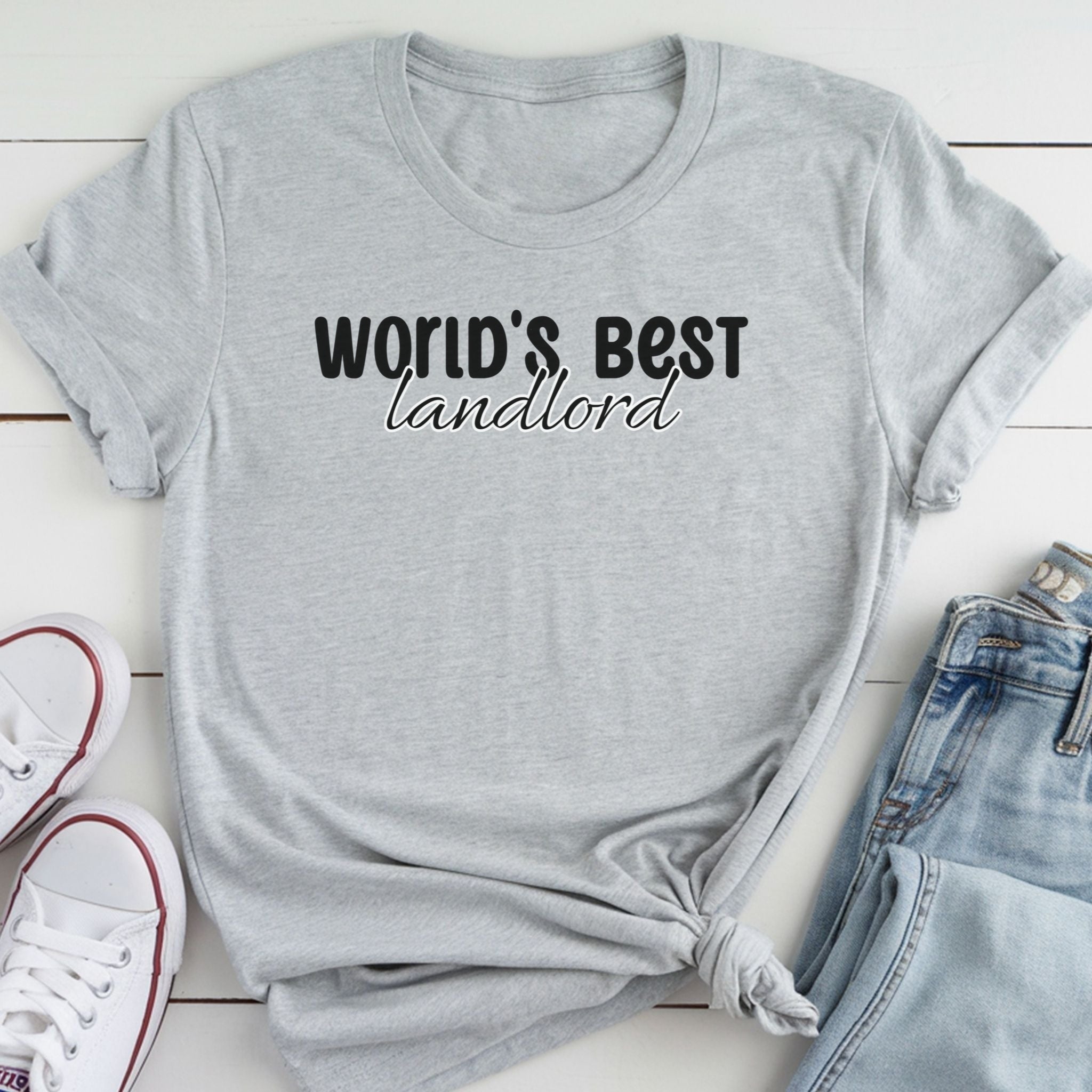 A gray t-shirt with the text "WORLD'S BEST landlORD" printed on it, along with a pair of jeans and white sneakers.