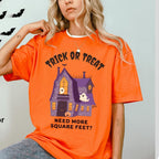 Person wearing an orange Halloween-themed t-shirt with text and graphics.