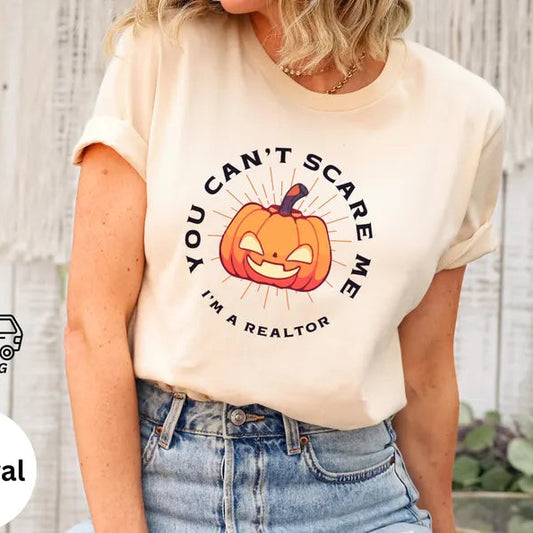 Person wearing a t-shirt with a Halloween-themed design and text, standing against a neutral background.