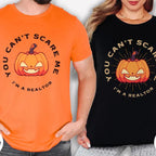 Two people wearing Halloween-themed t-shirts with a pumpkin graphic and text.